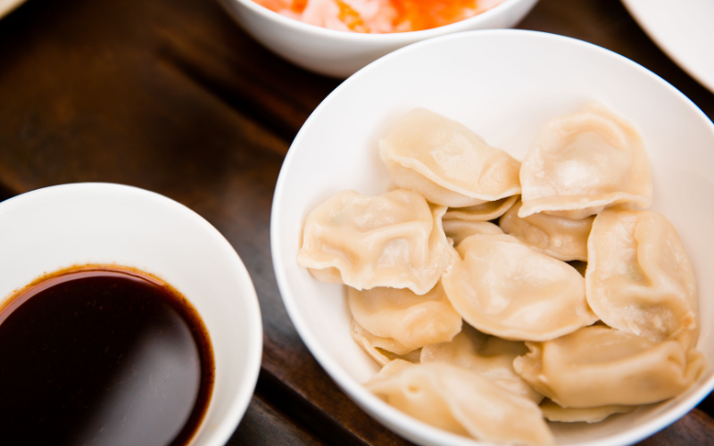 Dumplings in a bowl with Worcestershire dipping sauce bowl