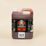 Bottle of Corporal Freddie's tomato sauce on a beige background