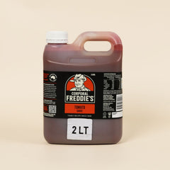 Bottle of Corporal Freddie's tomato sauce on a beige background