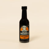 Bottle of Corporal Freddie's Worcestershire sauce on a beige background