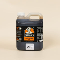 Bottle of Corporal Freddie's Worcestershire sauce on a beige background