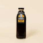 Bottle of 750ml Corporal Freddie's Worcestershire sauce on a beige background