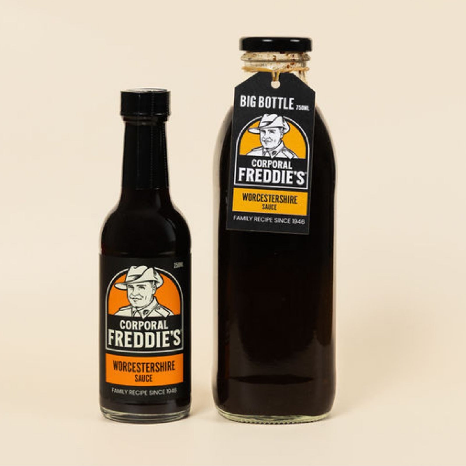 Two bottles of Corporal Freddie's Worcestershire sauce on a beige background
