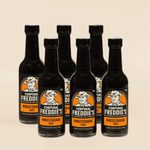 Six bottles of Corporal Freddie's Worcestershire sauce on a beige background