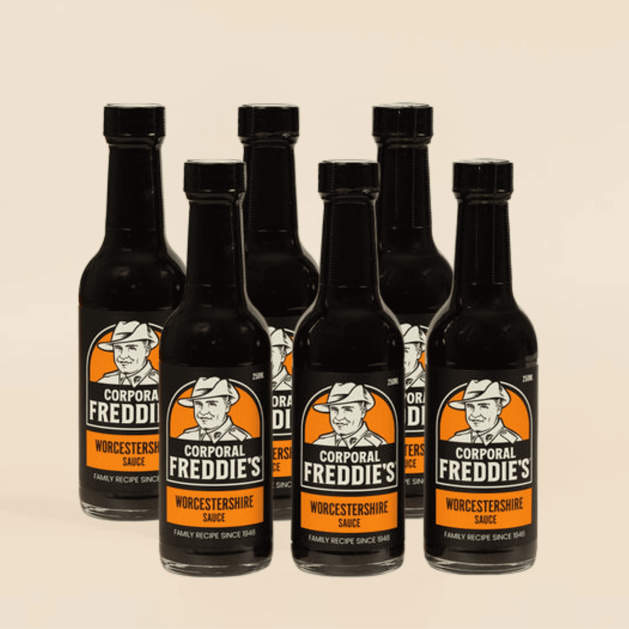 Six bottles of Corporal Freddie's Worcestershire sauce on a beige background